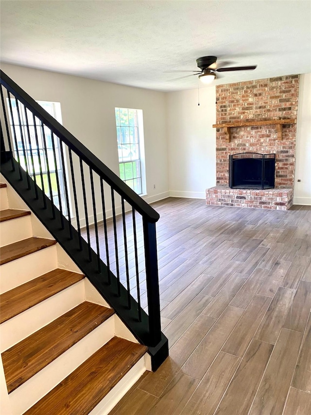 3211 Park Garden Dr, Houston, TX 77339 - stairs featuring ceiling fan, wood finished floors, and baseboards