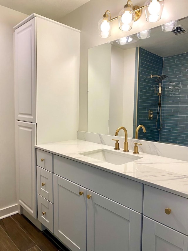 3211 Park Garden Dr, Houston, TX 77339 - full bathroom with vanity, a tile shower, and wood finished floors