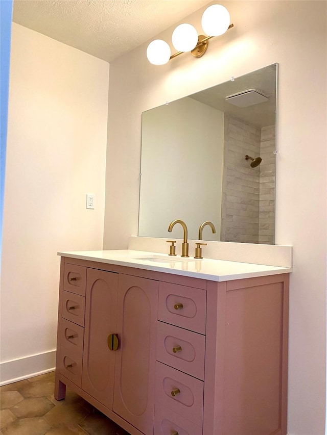 3211 Park Garden Dr, Houston, TX 77339 - full bath featuring vanity, baseboards, tiled shower, and a textured ceiling