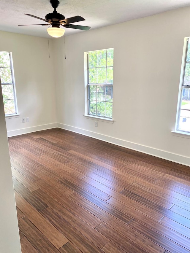3211 Park Garden Dr, Houston, TX 77339 - empty room with dark wood-style flooring, ceiling fan, and baseboards