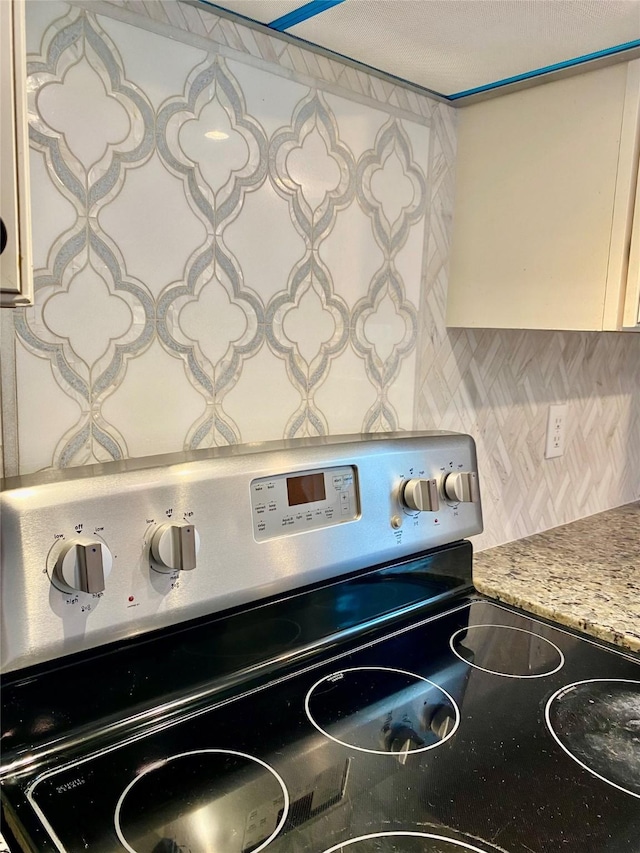3211 Park Garden Dr, Houston, TX 77339 - kitchen view of stainless steel electric range and tasteful backsplash