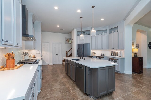 7 Fort Graham Ct, Missouri City, TX 77459 - kitchen featuring wall chimney exhaust hood, a sink, stainless steel dishwasher, gas cooktop, and arched walkways