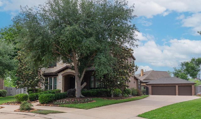 7 Fort Graham Ct, Missouri City, TX 77459 - obstructed view of property featuring concrete driveway, brick siding, an attached garage, and stone siding