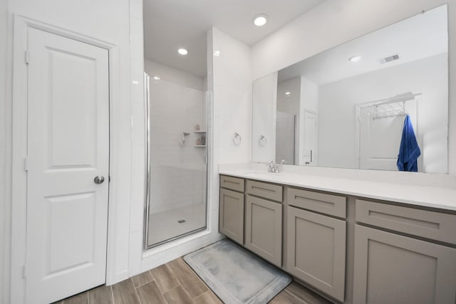 4214 Balboa Dr, Iowa Colony, TX 77583 - full bath featuring vanity, a shower stall, wood finished floors, and recessed lighting