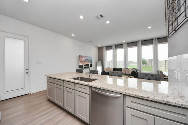 4214 Balboa Dr, Iowa Colony, TX 77583 - kitchen featuring dishwasher, a sink, light wood-style floors, light stone counters, and recessed lighting