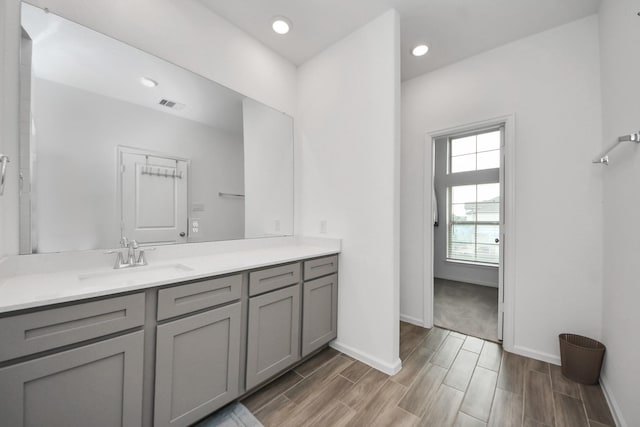 4214 Balboa Dr, Iowa Colony, TX 77583 - bathroom featuring vanity, wood finished floors, baseboards, and recessed lighting