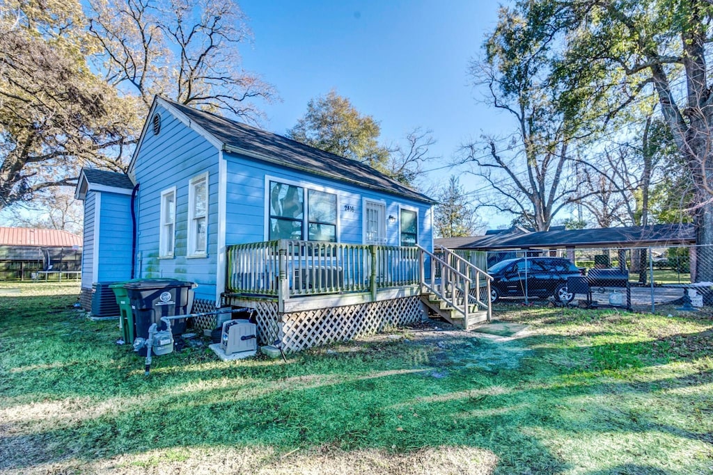 2416 Eastman St, Houston, TX 77009 - rear view of property featuring a carport and a wooden deck