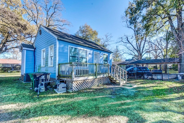 2416 Eastman St, Houston, TX 77009 - rear view of property featuring a carport and a wooden deck