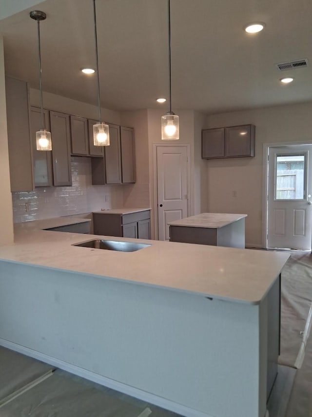 3603 Crosspointe Pass, Angleton, TX 77515 - kitchen with tasteful backsplash, recessed lighting, a peninsula, and hanging light fixtures