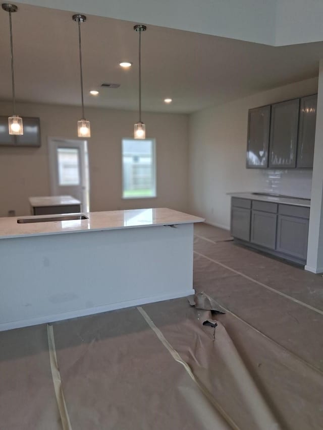 3603 Crosspointe Pass, Angleton, TX 77515 - kitchen with gray cabinets, decorative light fixtures, recessed lighting, and light countertops