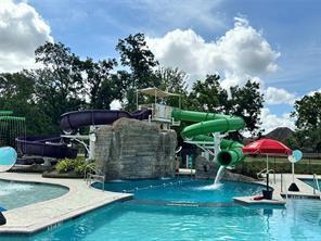 1311 Hudgins Pass, Richmond, TX 77469 - community pool with a water slide and a patio area