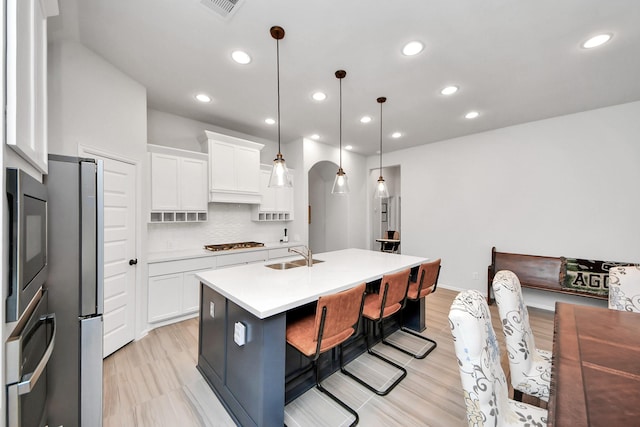 1311 Hudgins Pass, Richmond, TX 77469 - kitchen with appliances with stainless steel finishes, a sink, light countertops, recessed lighting, and white cabinetry