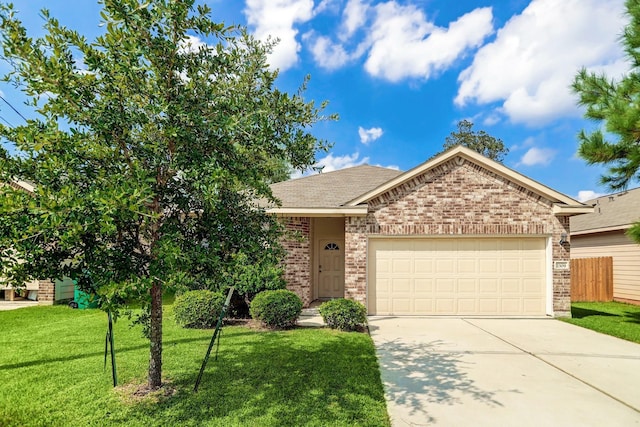 2309 Shady Tree Ln, Conroe, TX 77301 - view of front of home featuring brick siding, concrete driveway, and a garage