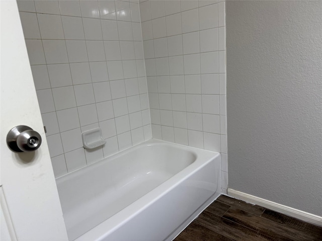 2309 Shady Tree Ln, Conroe, TX 77301 - full bathroom featuring wood finished floors, baseboards, and a textured wall