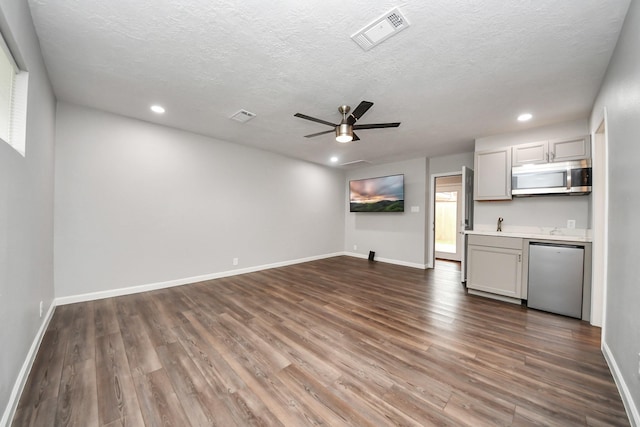 3111 Tanglebriar Dr, Pasadena, TX 77503 - unfurnished living room with dark wood-style floors, a ceiling fan, recessed lighting, a textured ceiling, and baseboards