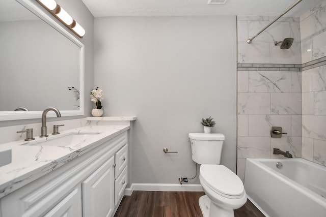 3111 Tanglebriar Dr, Pasadena, TX 77503 - full bathroom with vanity, toilet, wood finished floors, bathtub / shower combination, and baseboards