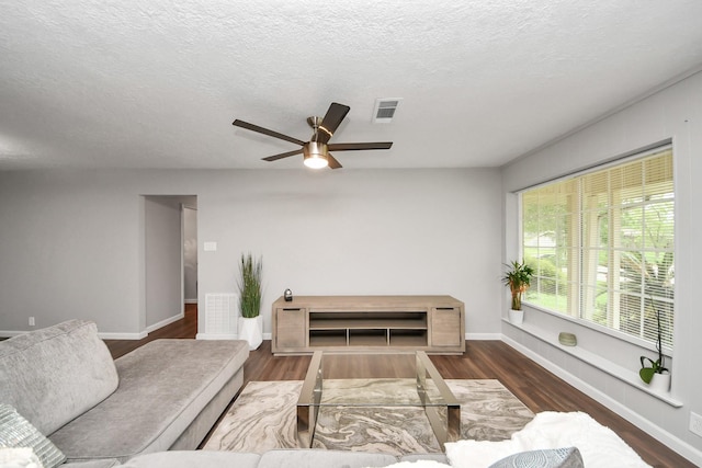 3111 Tanglebriar Dr, Pasadena, TX 77503 - living area with a ceiling fan, wood finished floors, a textured ceiling, and baseboards