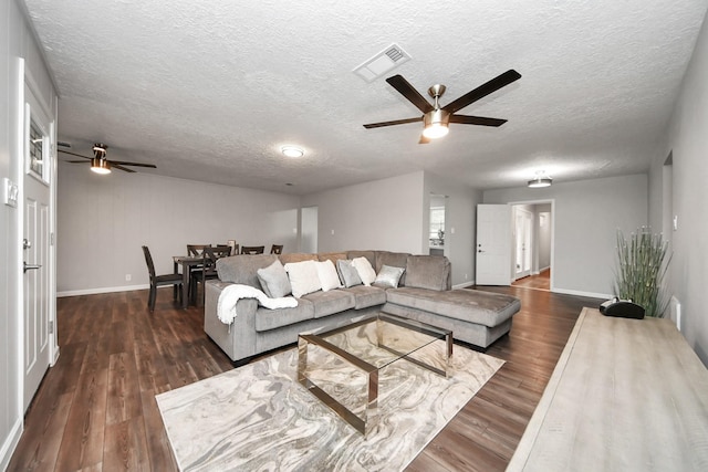 3111 Tanglebriar Dr, Pasadena, TX 77503 - living area with ceiling fan, a textured ceiling, baseboards, and dark wood-style flooring