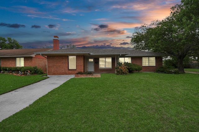 3111 Tanglebriar Dr, Pasadena, TX 77503 - ranch-style house featuring a front yard, a chimney, concrete driveway, and brick siding