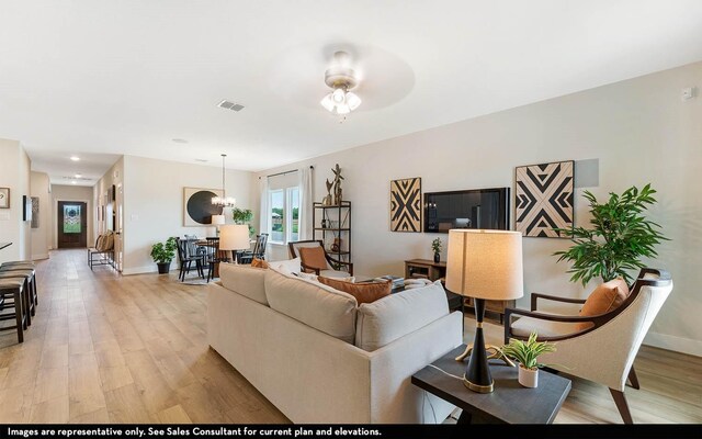 3644 Crosspointe Pass, Angleton, TX 77515 - living area featuring light wood-type flooring, baseboards, and ceiling fan