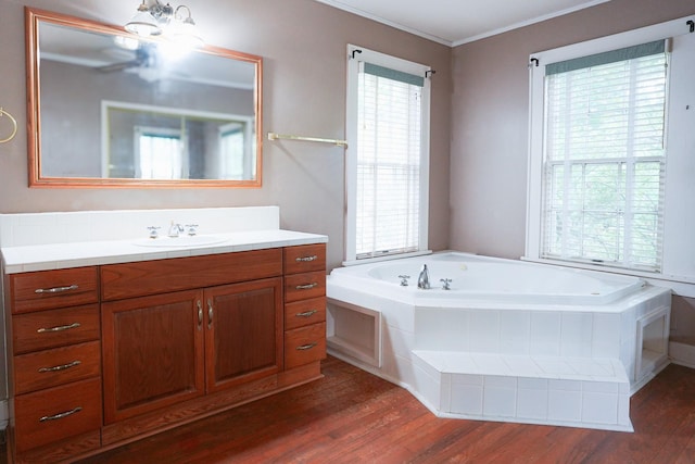 1514 Laurel St, La Marque, TX 77568 - full bathroom featuring vanity, a garden tub, wood finished floors, and crown molding