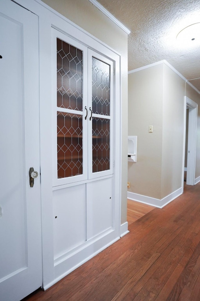 1514 Laurel St, La Marque, TX 77568 - corridor with wood finished floors, crown molding, baseboards, and a textured ceiling