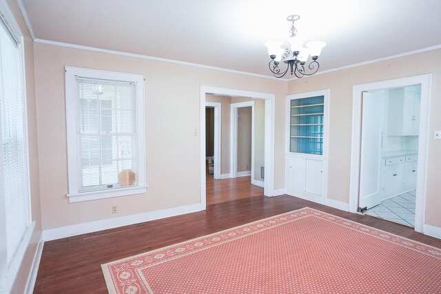 1514 Laurel St, La Marque, TX 77568 - unfurnished dining area with a chandelier, wood finished floors, crown molding, and baseboards