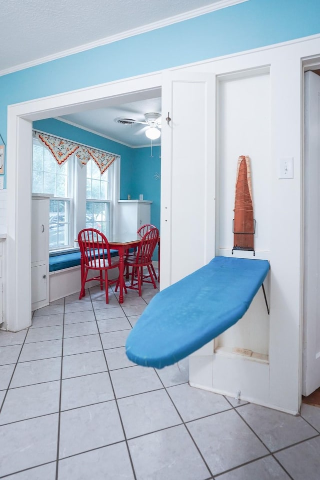 1514 Laurel St, La Marque, TX 77568 - dining room featuring light tile patterned flooring, ornamental molding, and a ceiling fan