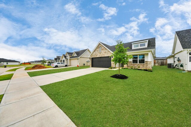 31811 Whittis Hill Way, Fulshear, TX 77441 - craftsman-style house with stone siding, driveway, a front lawn, a shingled roof, and a residential view