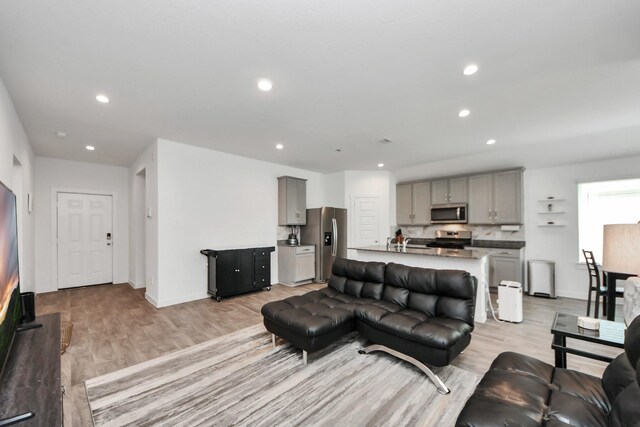 31811 Whittis Hill Way, Fulshear, TX 77441 - living area featuring light wood-style flooring, recessed lighting, and baseboards