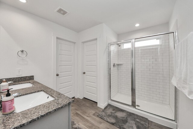 31811 Whittis Hill Way, Fulshear, TX 77441 - full bathroom with a shower stall, double vanity, wood finished floors, and recessed lighting