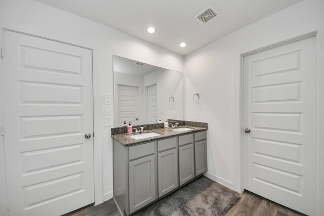 31811 Whittis Hill Way, Fulshear, TX 77441 - full bathroom featuring double vanity, wood finished floors, baseboards, and recessed lighting