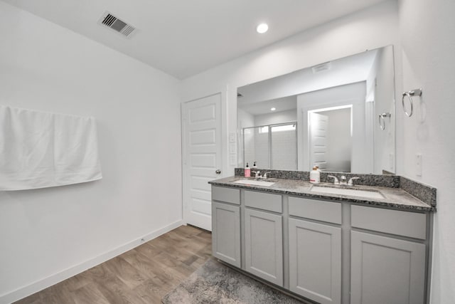 31811 Whittis Hill Way, Fulshear, TX 77441 - bathroom featuring a shower stall, wood finished floors, double vanity, baseboards, and recessed lighting