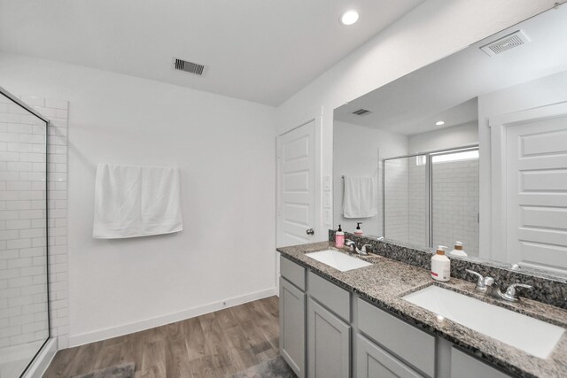 31811 Whittis Hill Way, Fulshear, TX 77441 - full bathroom featuring a shower stall, double vanity, wood finished floors, baseboards, and recessed lighting