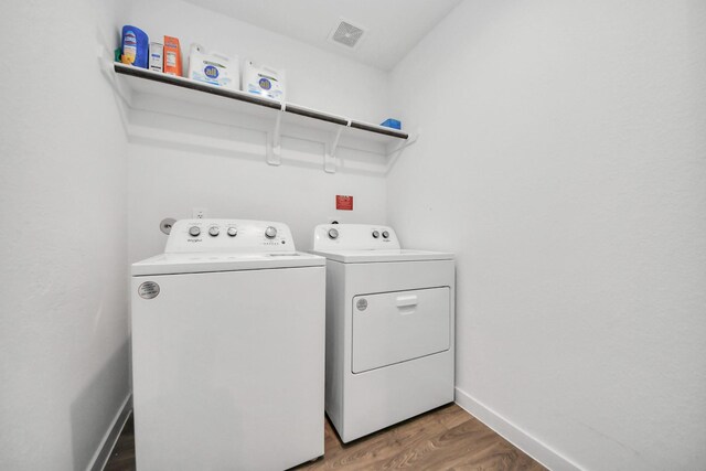 31811 Whittis Hill Way, Fulshear, TX 77441 - laundry area featuring washer and clothes dryer, wood finished floors, and baseboards