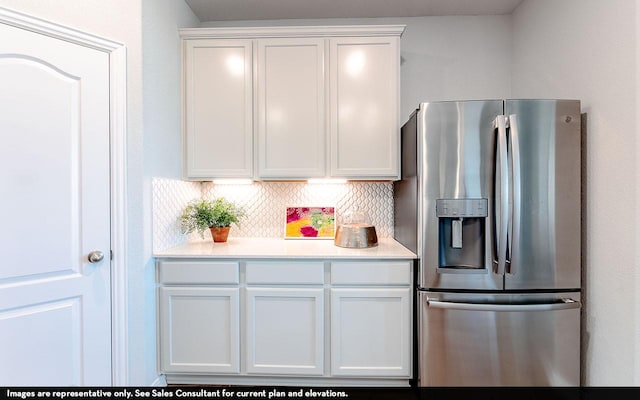 1726 Navigation Ln, Angleton, TX 77515 - kitchen with stainless steel refrigerator with ice dispenser, light countertops, tasteful backsplash, and white cabinets