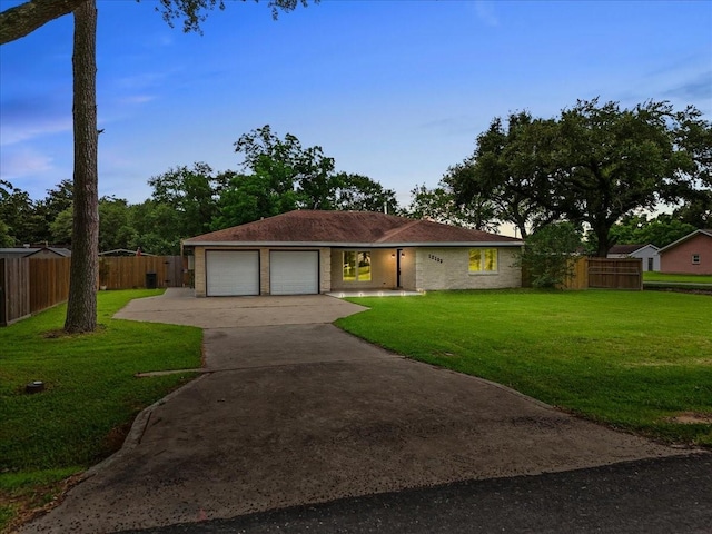 12153 24th St, Santa Fe, TX 77510 - ranch-style house featuring a garage and driveway