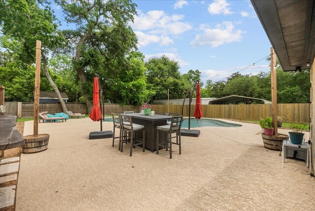 12153 24th St, Santa Fe, TX 77510 - fenced backyard with a patio and outdoor dining area