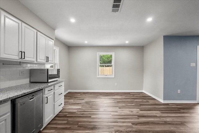 12153 24th St, Santa Fe, TX 77510 - kitchen with stainless steel appliances, white cabinetry, backsplash, baseboards, and recessed lighting