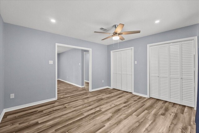 12153 24th St, Santa Fe, TX 77510 - unfurnished bedroom featuring wood finished floors, baseboards, a ceiling fan, and recessed lighting