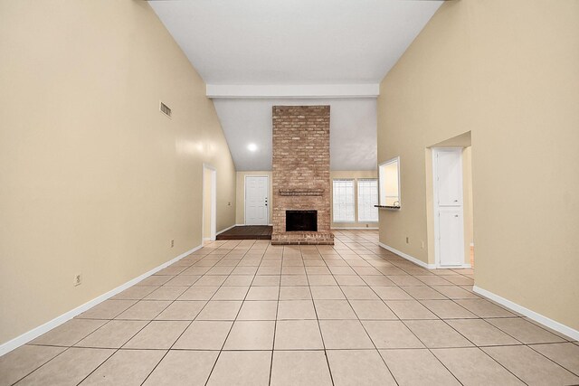 210 Squires Bnd, Stafford, TX 77477 - unfurnished living room featuring high vaulted ceiling, a brick fireplace, baseboards, and light tile patterned floors