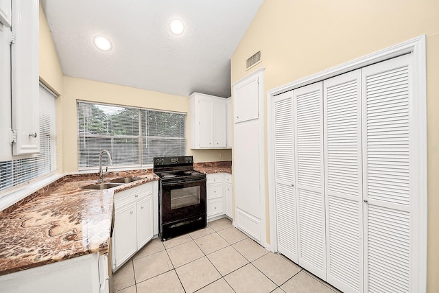 210 Squires Bnd, Stafford, TX 77477 - kitchen with black electric range oven, lofted ceiling, a sink, white cabinets, and light tile patterned floors