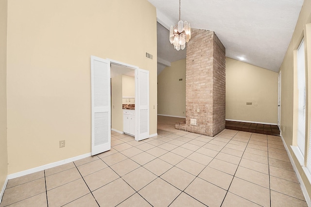 210 Squires Bnd, Stafford, TX 77477 - empty room with decorative columns, light tile patterned flooring, a chandelier, high vaulted ceiling, and baseboards