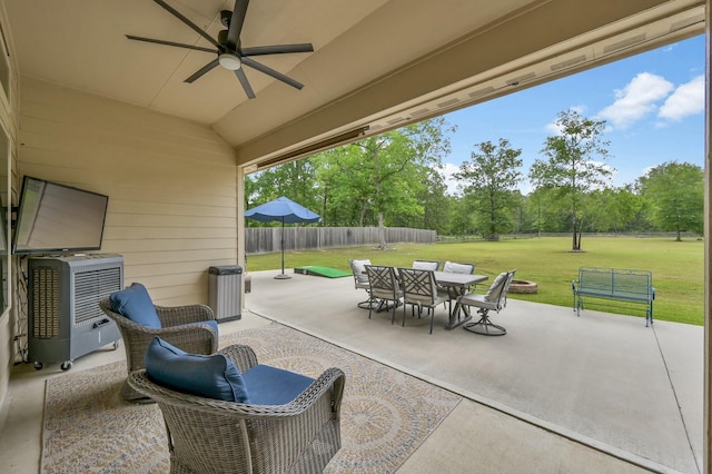 9175 White Tail Dr, Conroe, TX 77303 - view of patio featuring outdoor dining space, a ceiling fan, and view of scattered trees