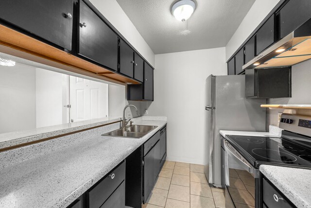 206 Plaza Verde Dr Unit D35, Houston, TX 77038 - kitchen featuring stainless steel range with electric stovetop, a sink, extractor fan, light countertops, and dark cabinetry