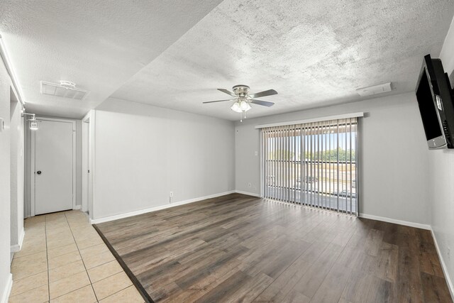 206 Plaza Verde Dr Unit D35, Houston, TX 77038 - spare room with a textured ceiling, ceiling fan, baseboards, and wood finished floors