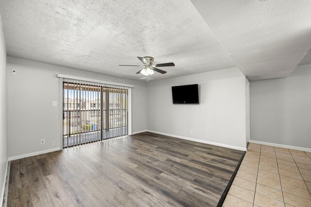 206 Plaza Verde Dr Unit D35, Houston, TX 77038 - empty room with a textured ceiling, a ceiling fan, baseboards, and wood finished floors