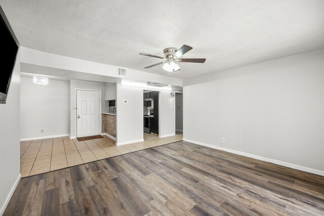 206 Plaza Verde Dr Unit D35, Houston, TX 77038 - unfurnished room with wood finished floors, a ceiling fan, a textured ceiling, and baseboards