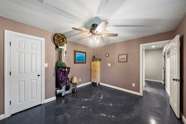 424 Hankamer Loop, Hankamer, TX 77560 - foyer featuring baseboards, ceiling fan, a textured ceiling, and concrete floors