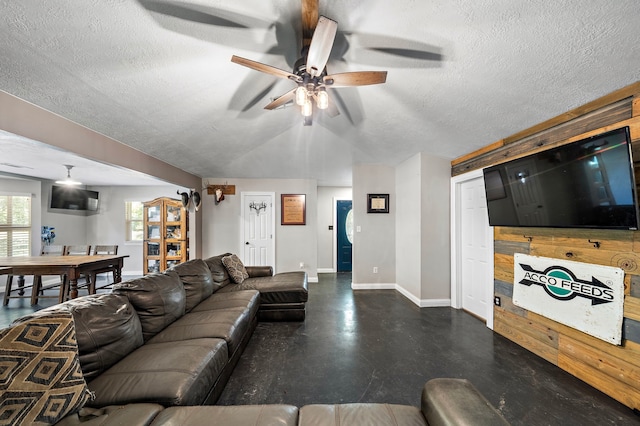 424 Hankamer Loop, Hankamer, TX 77560 - living area with baseboards, ceiling fan, a textured ceiling, finished concrete floors, and wood walls